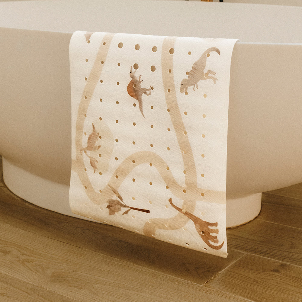 tapis de bain le dino exposé sur la baignoire