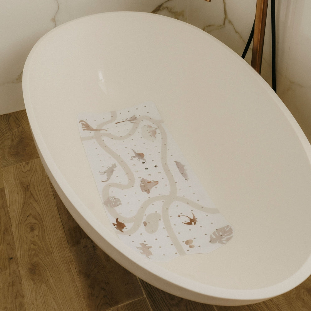 tapis de bain le dino motif dinosaure mis dans la baignoire